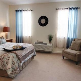 A cozy bedroom with a stylish decor and natural lighting.