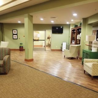 A welcoming lobby space featuring comfortable seating and green decor.