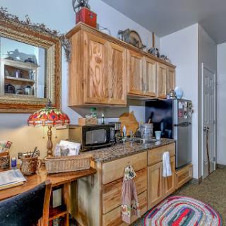 A cozy kitchen featuring wooden cabinets and a decorative touch.