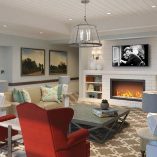 A modern living room with a cozy fireplace, stylish furniture, and artwork on display.