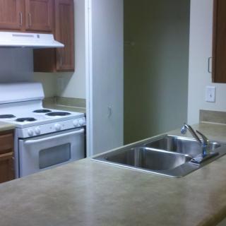 A clean kitchen with a stove and sink.