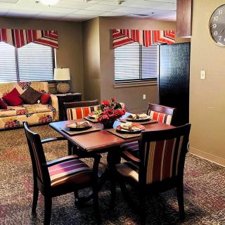 A cozy dining and living area with warm colors and stylish furniture.