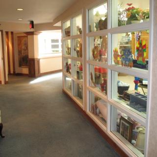 A hallway with glass display cases showcasing various artifacts.
