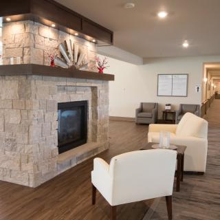 A modern lobby with a stone fireplace, comfortable seating, and elegant decor.