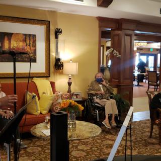 A cozy lobby with people relaxing on comfortable furniture, creating a warm social atmosphere.