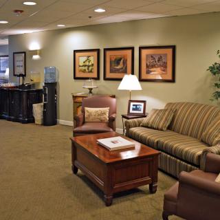 A cozy waiting room with comfortable seating and warm lighting.