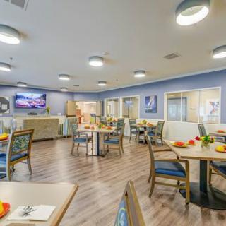 A bright and modern dining room with neatly arranged tables and chairs.