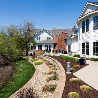 A beautiful modern house with landscaped garden and curving pathway.