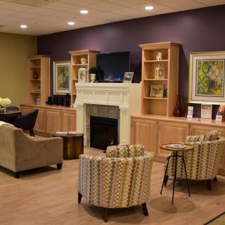 A cozy living room with a fireplace, television, and comfortable seating.
