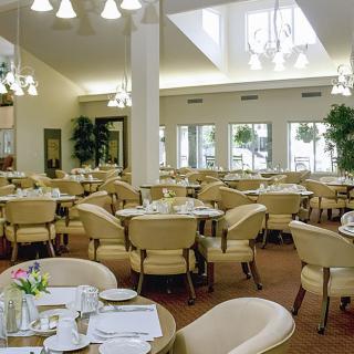 An elegant dining room with neatly arranged tables and chairs, ready for guests.