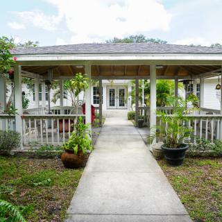 A charming house with a covered porch and garden pathway leading to the entrance.