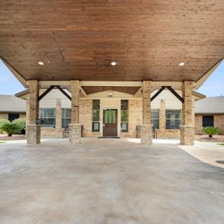 A welcoming entrance to a modern residential building with a covered porch.
