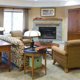 A cozy living room with comfortable seating and a fireplace.