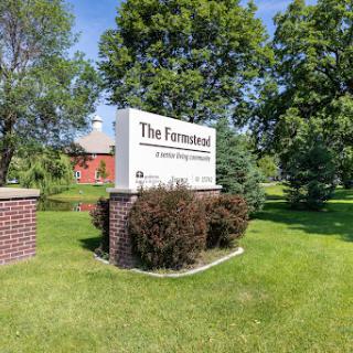 The sign for 'The Fermentalist' surrounded by lush greenery.