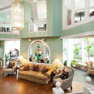 A luxurious and spacious living room with elegant furnishings and large windows.