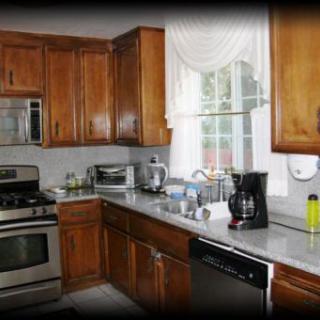 A modern kitchen with wooden cabinets and stainless steel appliances.