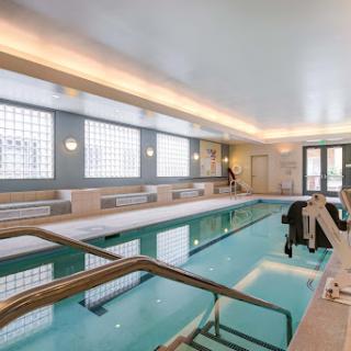 A serene indoor swimming pool featuring modern design elements and ample natural light.
