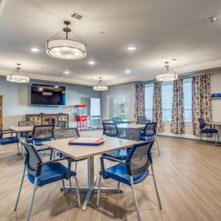A modern and spacious dining area with stylish lighting and seating arrangements.