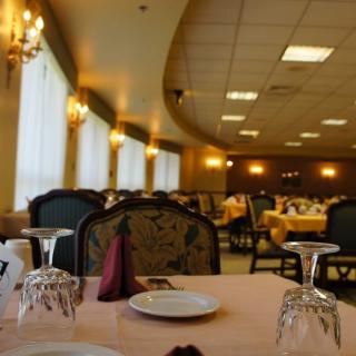 An elegant dining room in a restaurant with neatly arranged tables and chairs.