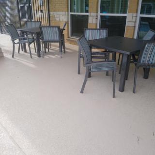 Outdoor patio area with tables and chairs.