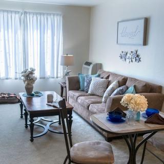 A cozy and well-decorated living room with a comfortable sofa and elegant coffee table.
