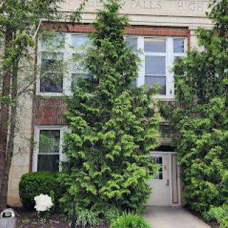 A well-manicured entrance with lush greenery flanking the doorway.