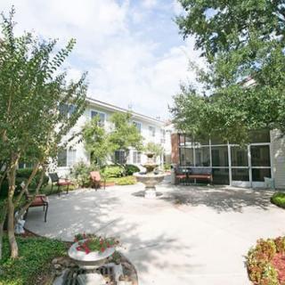 A spacious courtyard with greenery and comfortable seating, perfect for relaxation.