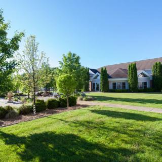 A beautiful house surrounded by a landscaped garden on a sunny day.