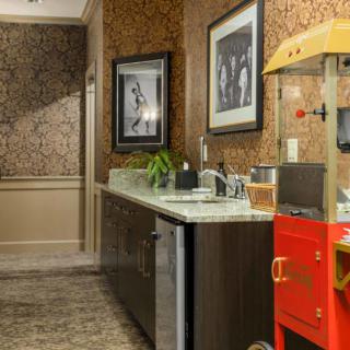 A well-decorated kitchen corner featuring a vintage popcorn machine and framed wall art.