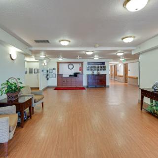 A spacious and welcoming lobby area featuring comfortable furniture and decorative plants.