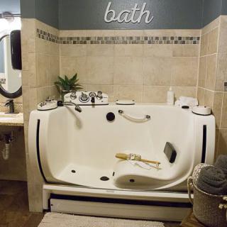 A luxurious bathroom features a spacious bathtub with modern fixtures and elegant decor.