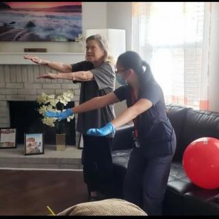 Two people engage in a fun exercise routine in the living room.