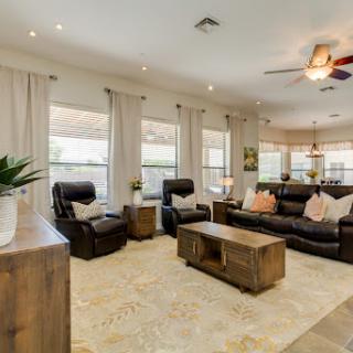 A cozy and inviting living room featuring comfortable seating, natural light, and a blend of modern furnishings.