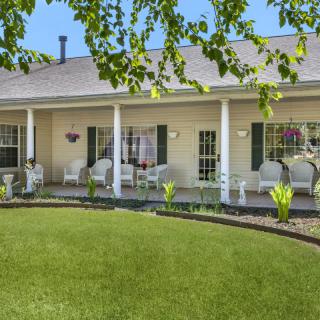 A charming house with a well-maintained lawn and inviting porch.