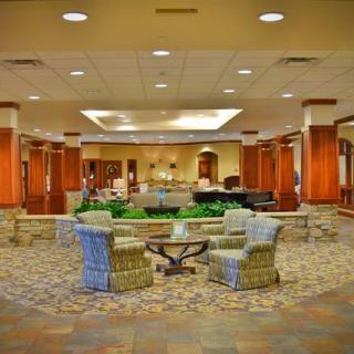 A spacious and elegantly decorated lobby featuring comfortable seating arrangements.