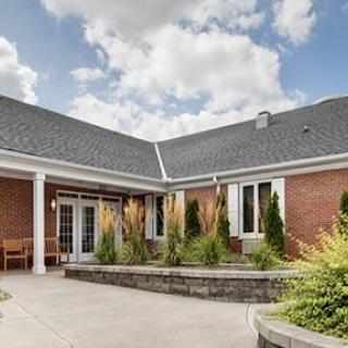 A beautiful residential courtyard showcasing brick architecture and lush landscaping.