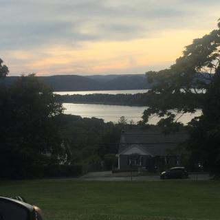 A serene view of a lake and trees at sunset.