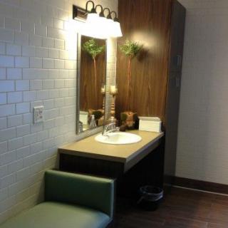 Modern bathroom vanity with a well-lit mirror and sink.