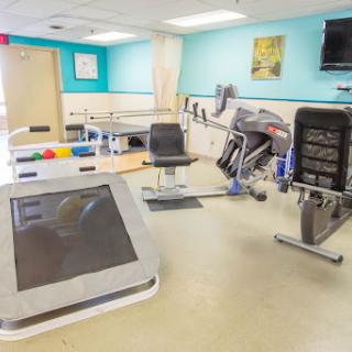 A well-equipped rehabilitation center featuring various exercise machines and a bright, inviting atmosphere.