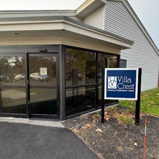 Entrance to a building with a sign that reads 'Villa Crest Nursing and Retirement Center'.