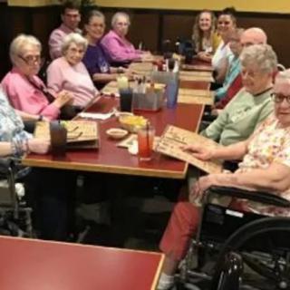 A group of seniors enjoying a meal together at a restaurant.