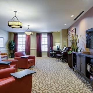 A well-furnished living room with comfortable seating, television, and elegant decor.