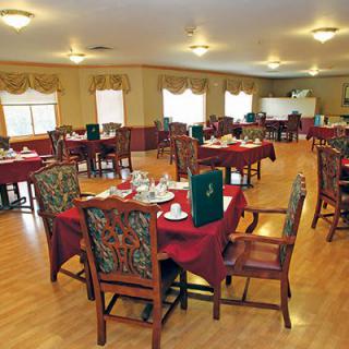 An elegant dining room with neatly arranged tables and chairs.