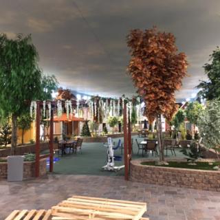 A beautifully designed indoor recreational space featuring artificial trees and a serene atmosphere.
