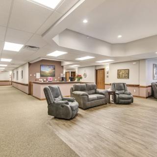 A well-lit lobby area with comfortable seating and a reception desk.
