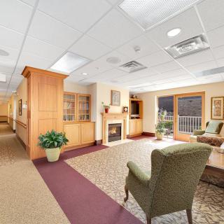 A cozy lobby area with comfortable seating, a fireplace, and decorative elements.