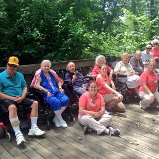 A group of seniors enjoying a sunny day outdoors in the park.