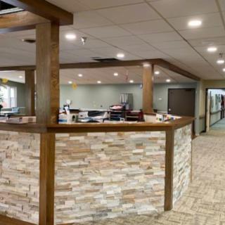 A modern office reception area with a stone finish desk and ambient lighting.