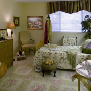 A traditional bedroom with floral bedding and elegant decor.