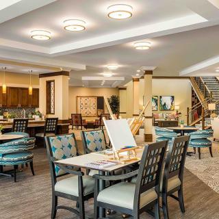 A spacious and modern dining room with stylish furnishings and bright lighting.